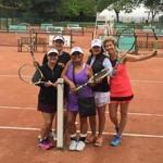 A group of Grand Slam Tennis Tours clients on the clay courts at the Tennis Club de Paris.